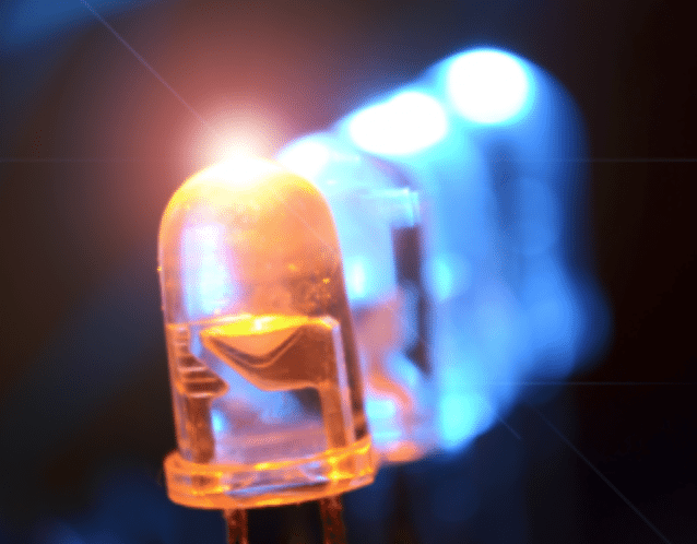 A line of LEDs, three blue and one orange.