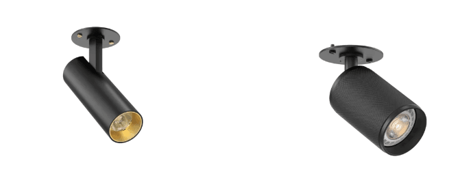 wo black cylindrical ceiling-mounted spotlights with round base plates, shown on a white background, designed for conduit or surface-mounted lighting installations.